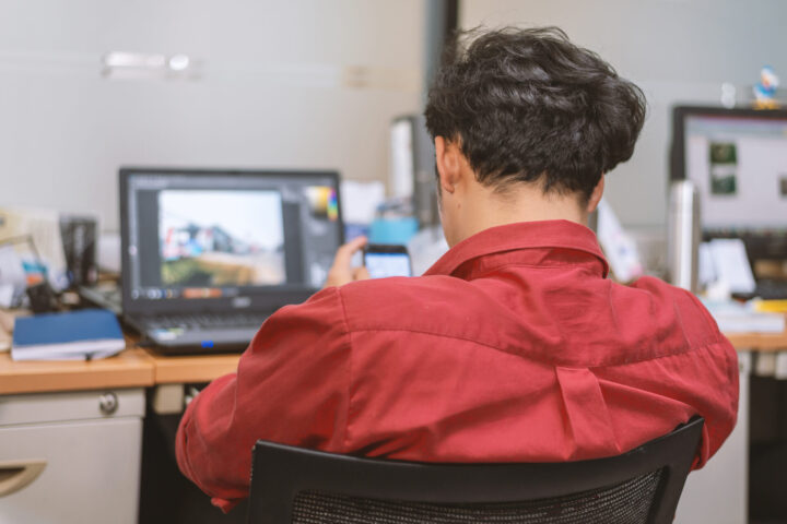 business man working in office with soft-focus and over light in the background