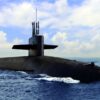 Naval submarine on open blue sea surface