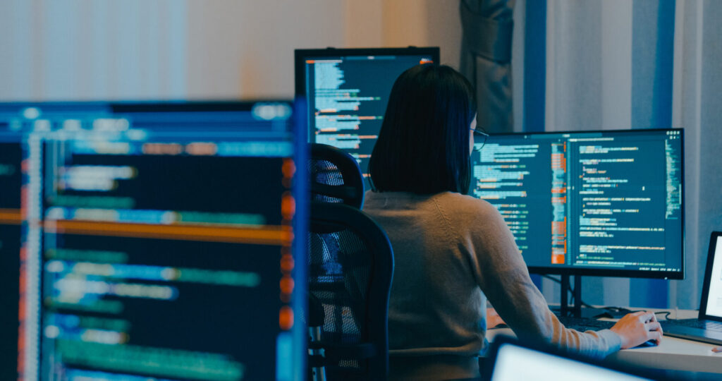 AI Artificial intelligence, technology Young female freelance eyeglasses typing write prompt AI bot IT app smart program nomad, video game, terminal with coding language, designer, big data center on desktop computer in night office.