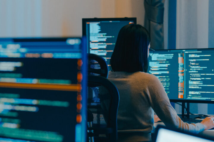 AI Artificial intelligence, technology Young female freelance eyeglasses typing write prompt AI bot IT app smart program nomad, video game, terminal with coding language, designer, big data center on desktop computer in night office.