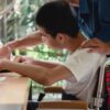 Teaching assistant helping a SEN pupil