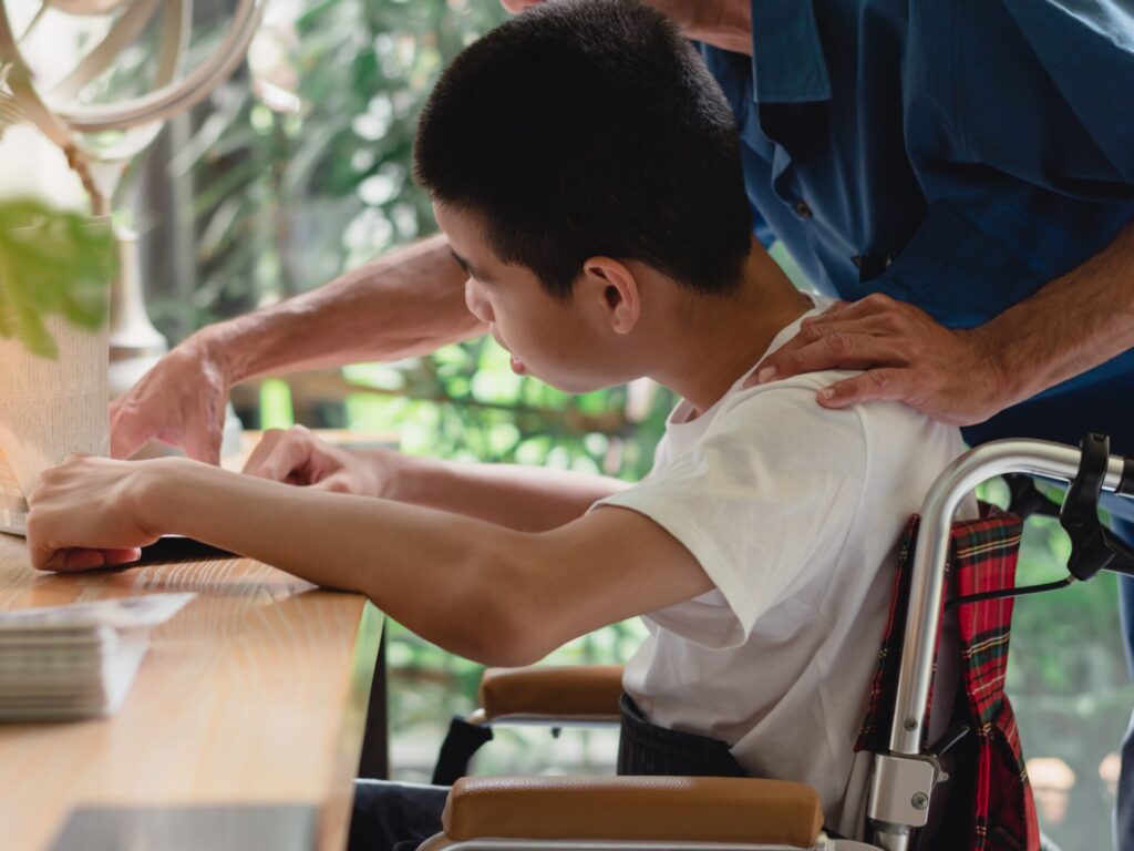 Teaching assistant helping a SEN pupil