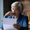 Old lady looking at financial document