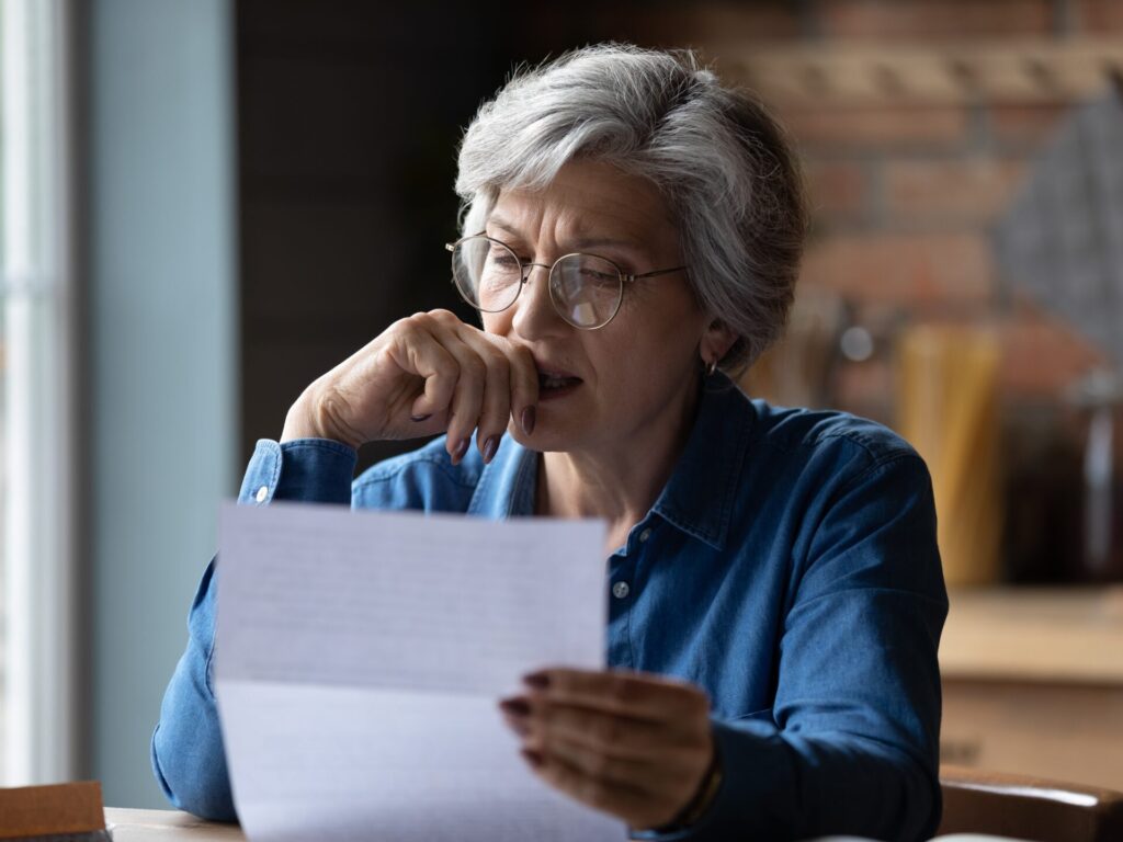 Old lady looking at financial document