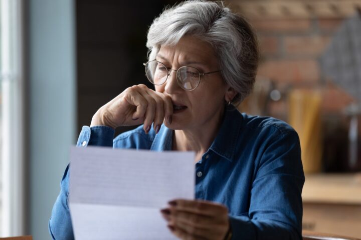Old lady looking at financial document