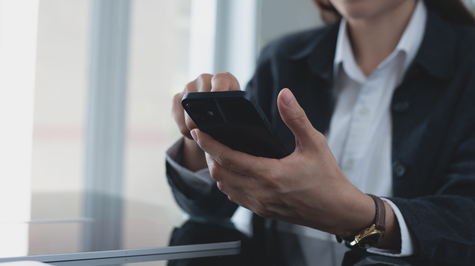 Close up, business woman using mobile phone at modern office. Businesswoman hand holding smartphone, surfing the internet, social media networking with copy space