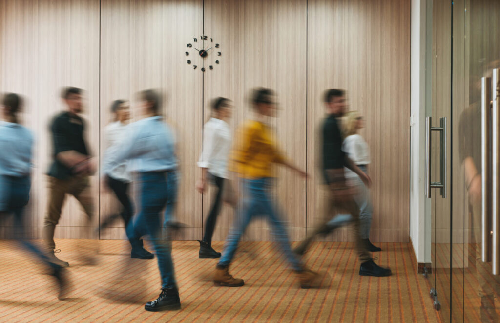 Group of office people walking at office open space. Team of business employees at coworking center. People at motion blur. Concept working at action