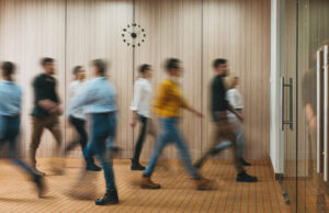 Group of office people walking at office open space. Team of business employees at coworking center. People at motion blur. Concept working at action