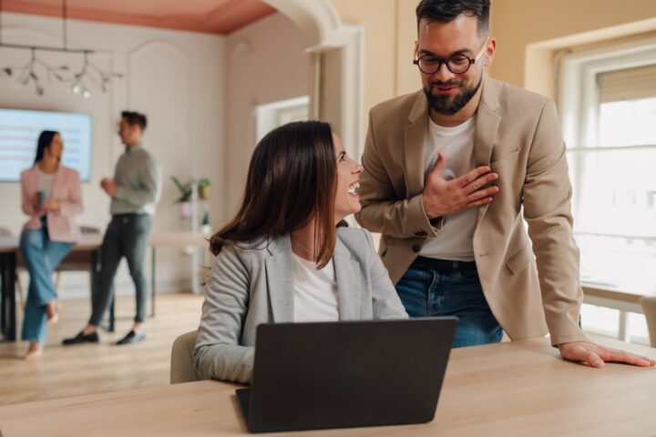 Managers expressing gratitude and appreciation to employee using laptop in the office. Thanking colleague