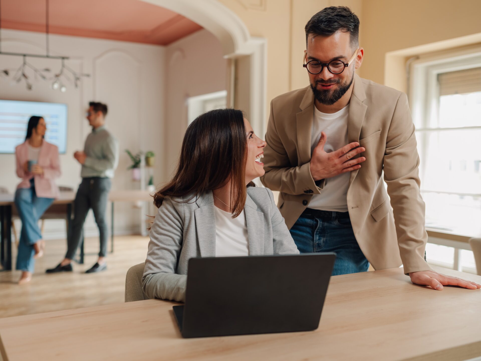 Managers expressing gratitude and appreciation to employee using laptop in the office. Thanking colleague