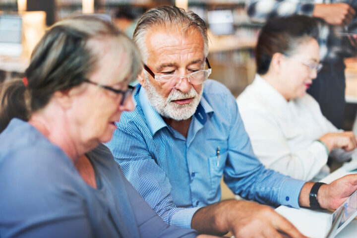older people work creative Seniors studying together at the library