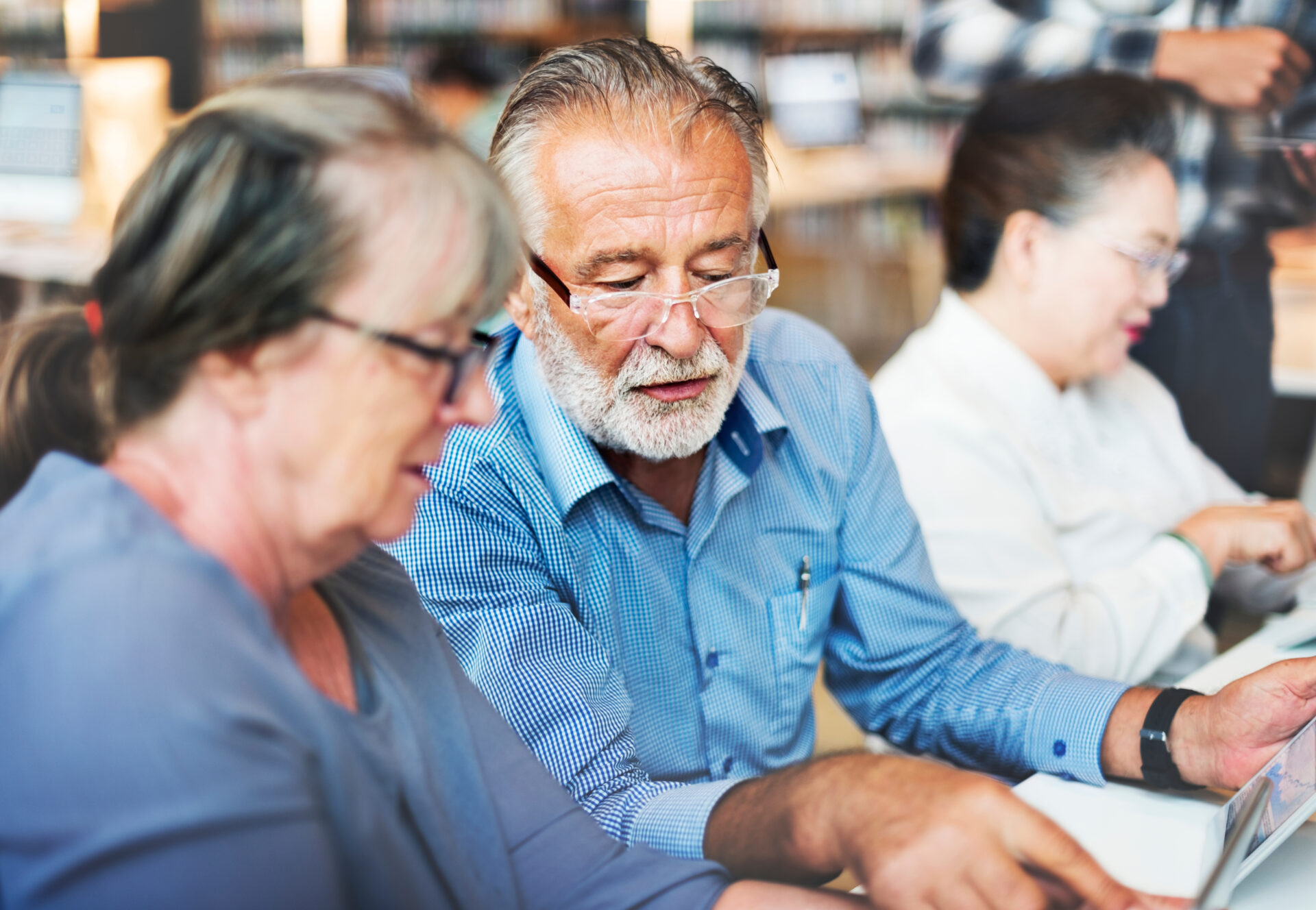 older people work creative Seniors studying together at the library