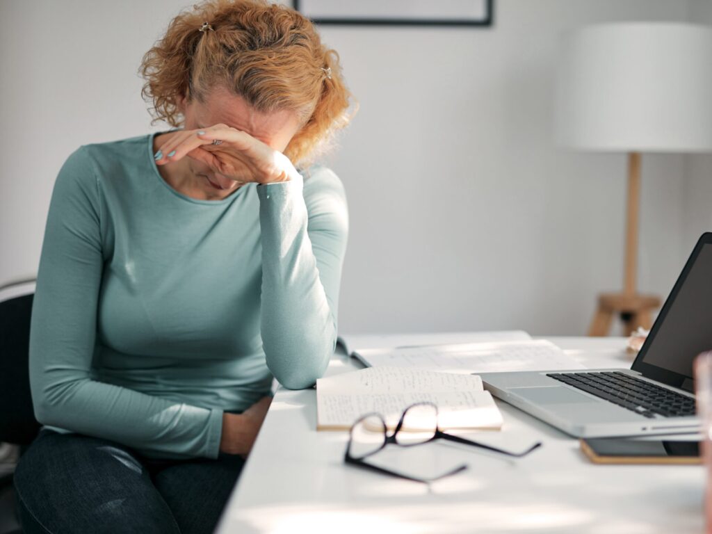 Women with period pain at work